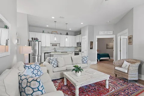 a living room with furniture and kitchen view