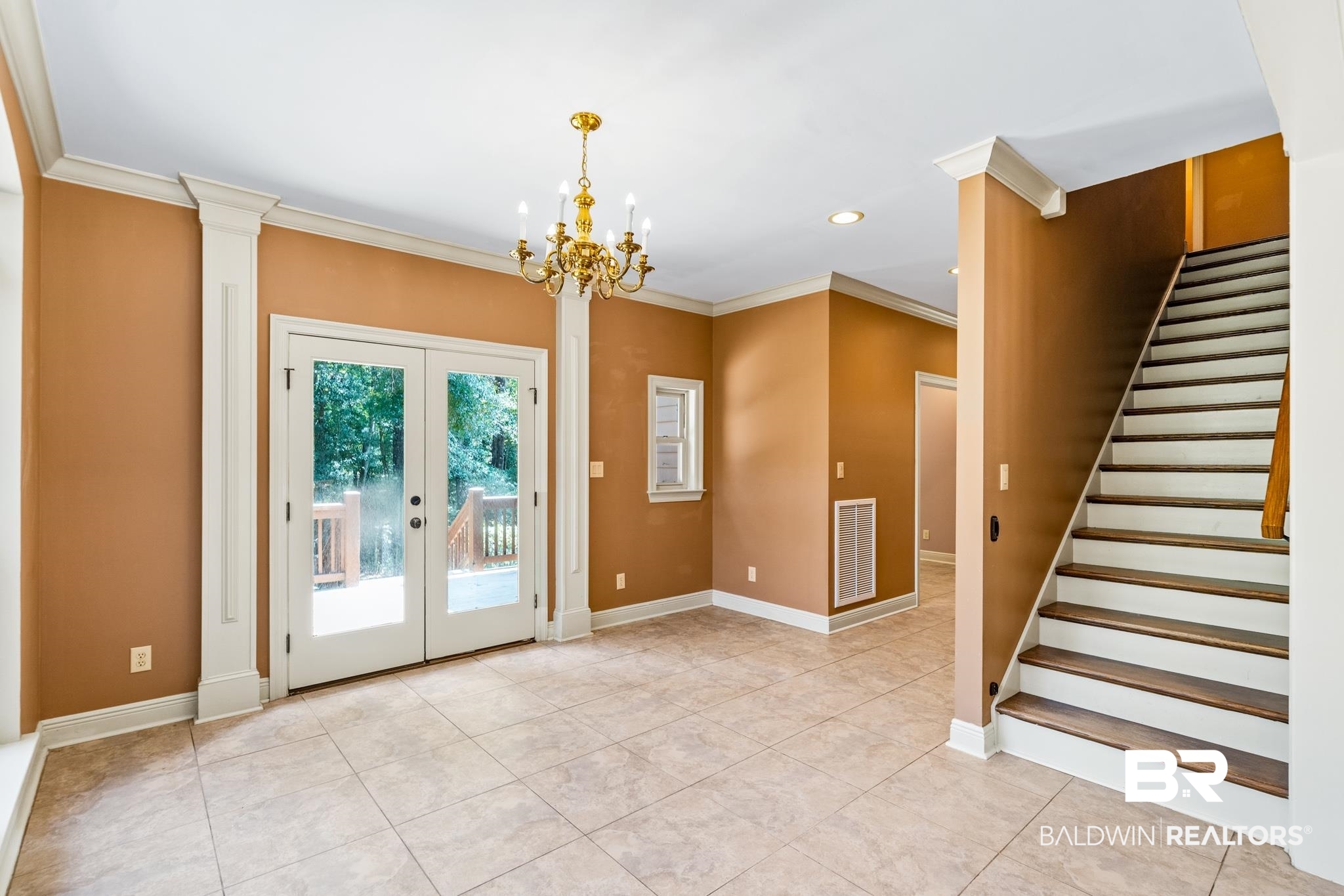 8321 Dixon Road Bay Minette, AL 36507 - Photo 33 of 79 Interior space featuring french doors, ornate columns, crown molding, and an inviting chandelier