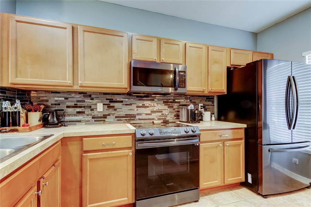 8504 Gablebend Way Tampa, FL 33647 - Photo 14 of 34 a kitchen with a stove a sink and a refrigerator
