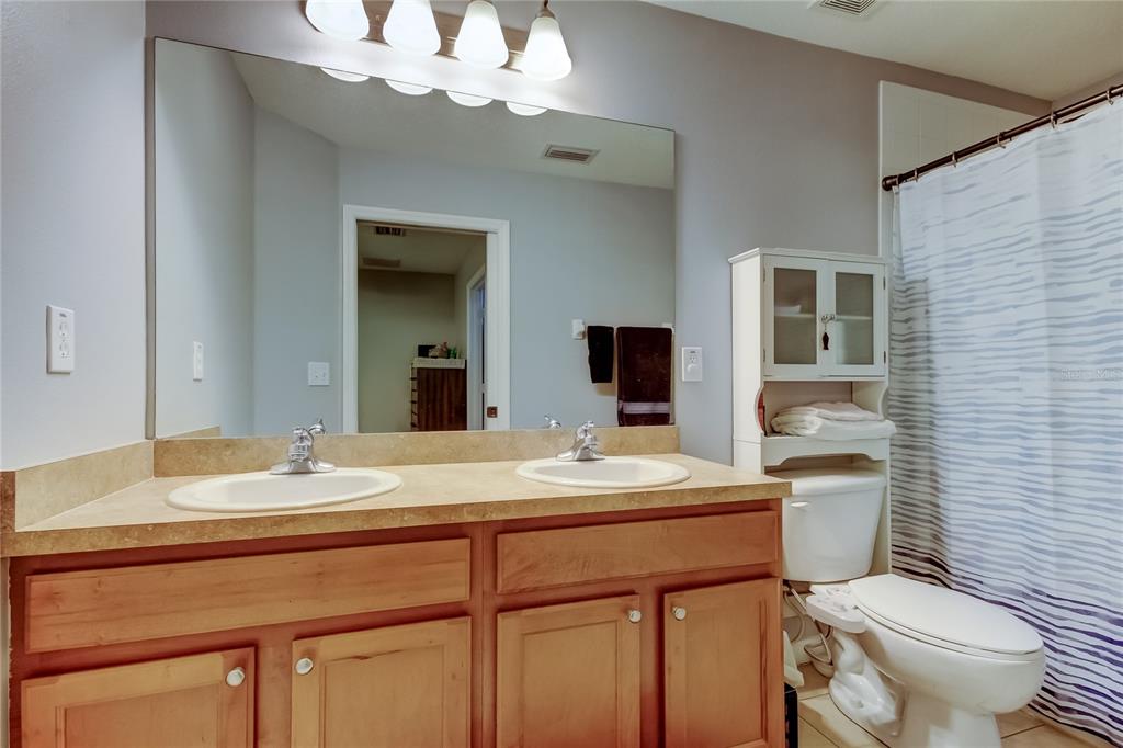 8504 Gablebend Way Tampa, FL 33647 - Photo 21 of 34 a bathroom with a sink a toilet and mirror
