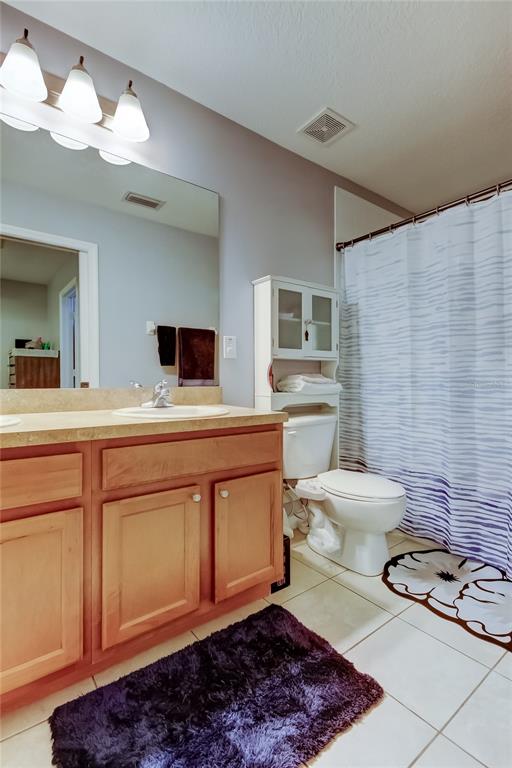 8504 Gablebend Way Tampa, FL 33647 - Photo 22 of 34 a bathroom with a sink a toilet and mirror
