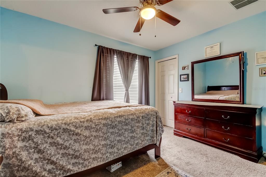 8504 Gablebend Way Tampa, FL 33647 - Photo 24 of 34 a bedroom with a bed and a flat screen tv