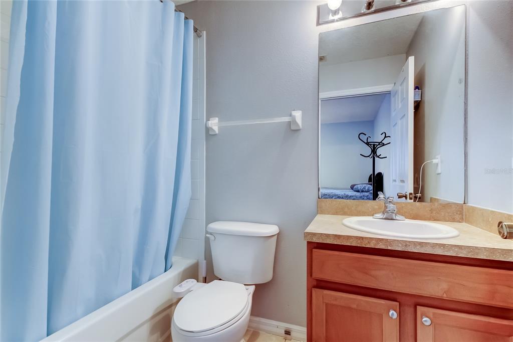 8504 Gablebend Way Tampa, FL 33647 - Photo 25 of 34 a bathroom with a granite countertop toilet sink and mirror