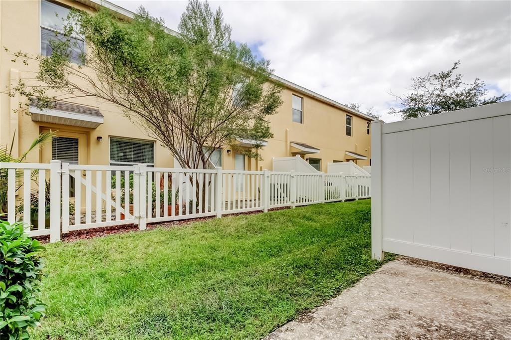 8504 Gablebend Way Tampa, FL 33647 - Photo 29 of 34 a view of a house with a small yard and wooden fence
