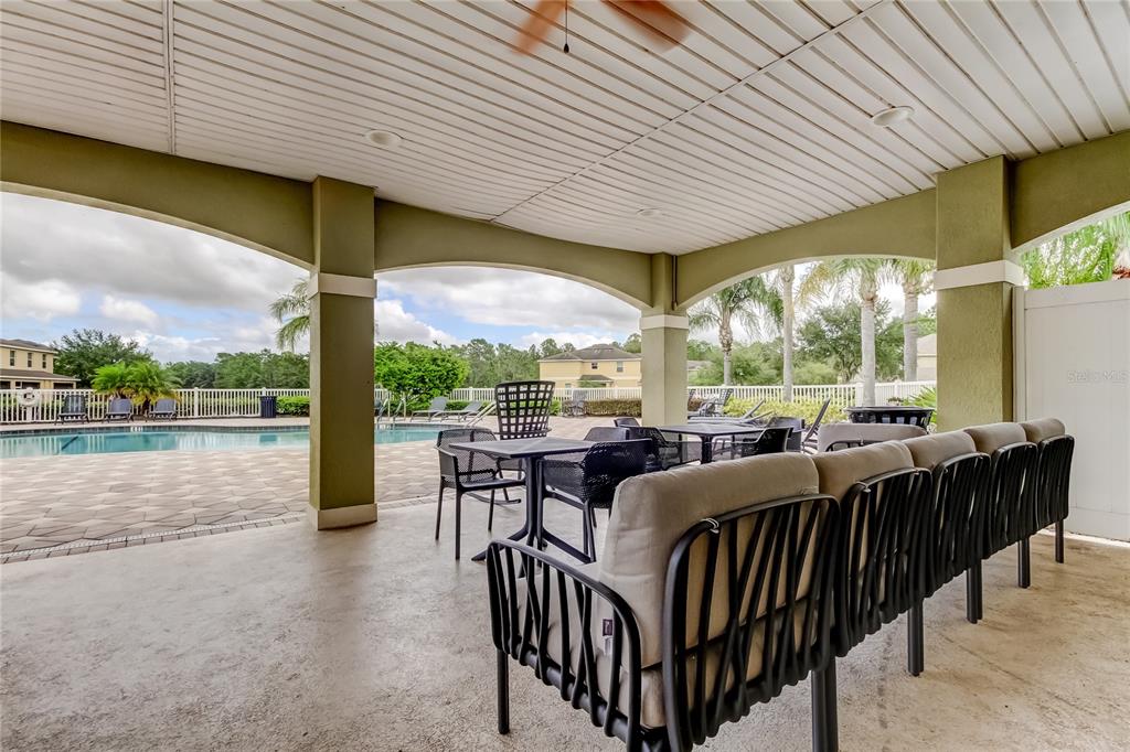 8504 Gablebend Way Tampa, FL 33647 - Photo 33 of 34 a view of a patio with table and chairs and wooden floor
