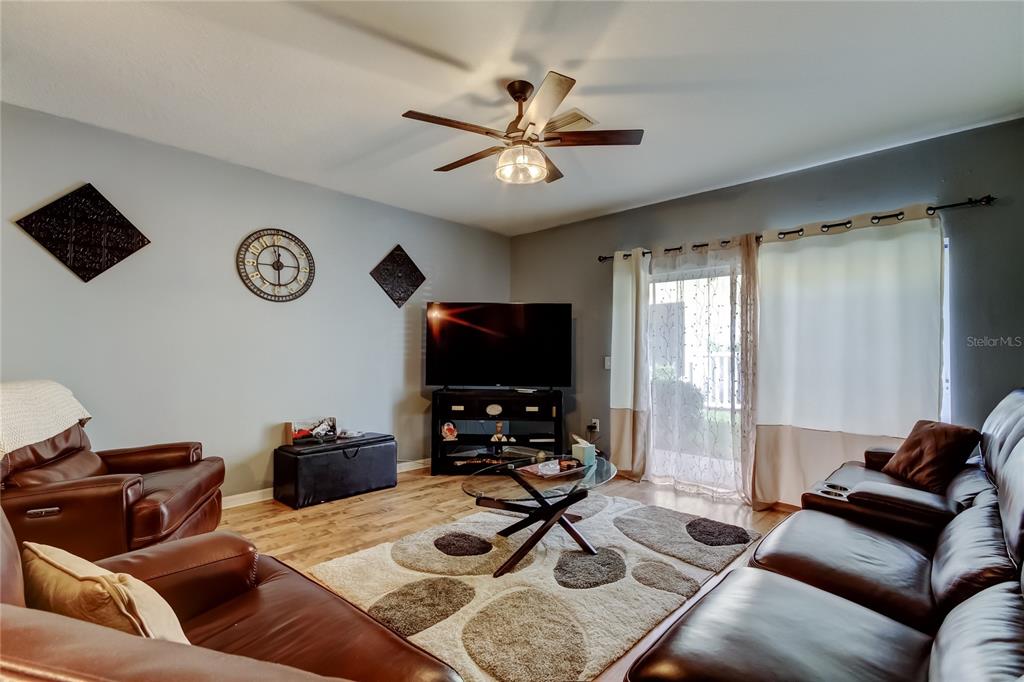 8504 Gablebend Way Tampa, FL 33647 - Photo 6 of 34 a living room with furniture and a flat screen tv
