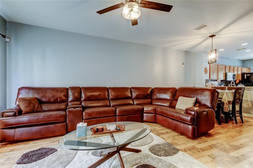 8504 Gablebend Way Tampa, FL 33647 - Photo 7 of 34 a living room with furniture and a chandelier