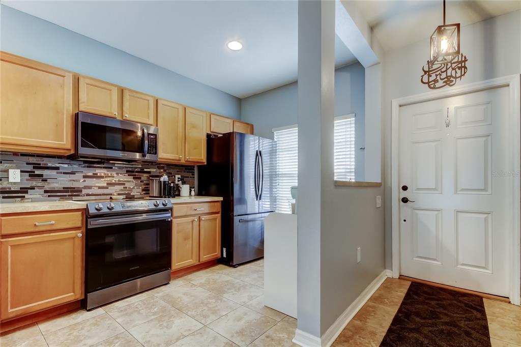 8504 Gablebend Way Tampa, FL 33647 - Photo 9 of 34 a kitchen with stainless steel appliances granite countertop a refrigerator stove and sink