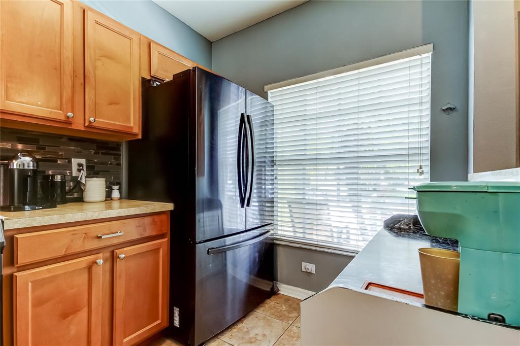 8504 Gablebend Way Tampa, FL 33647 - Photo 10 of 34 a kitchen with a refrigerator and cabinets