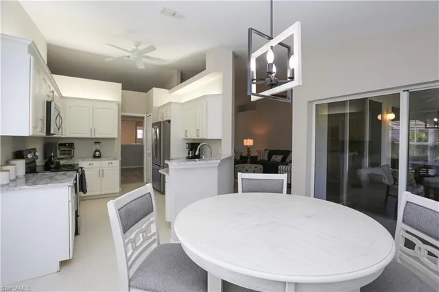 a kitchen with kitchen island a sink appliances and cabinets