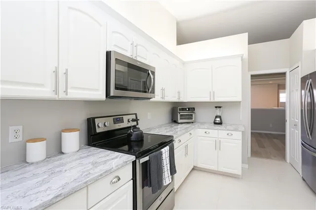 a kitchen with stainless steel appliances granite countertop a sink and a stove