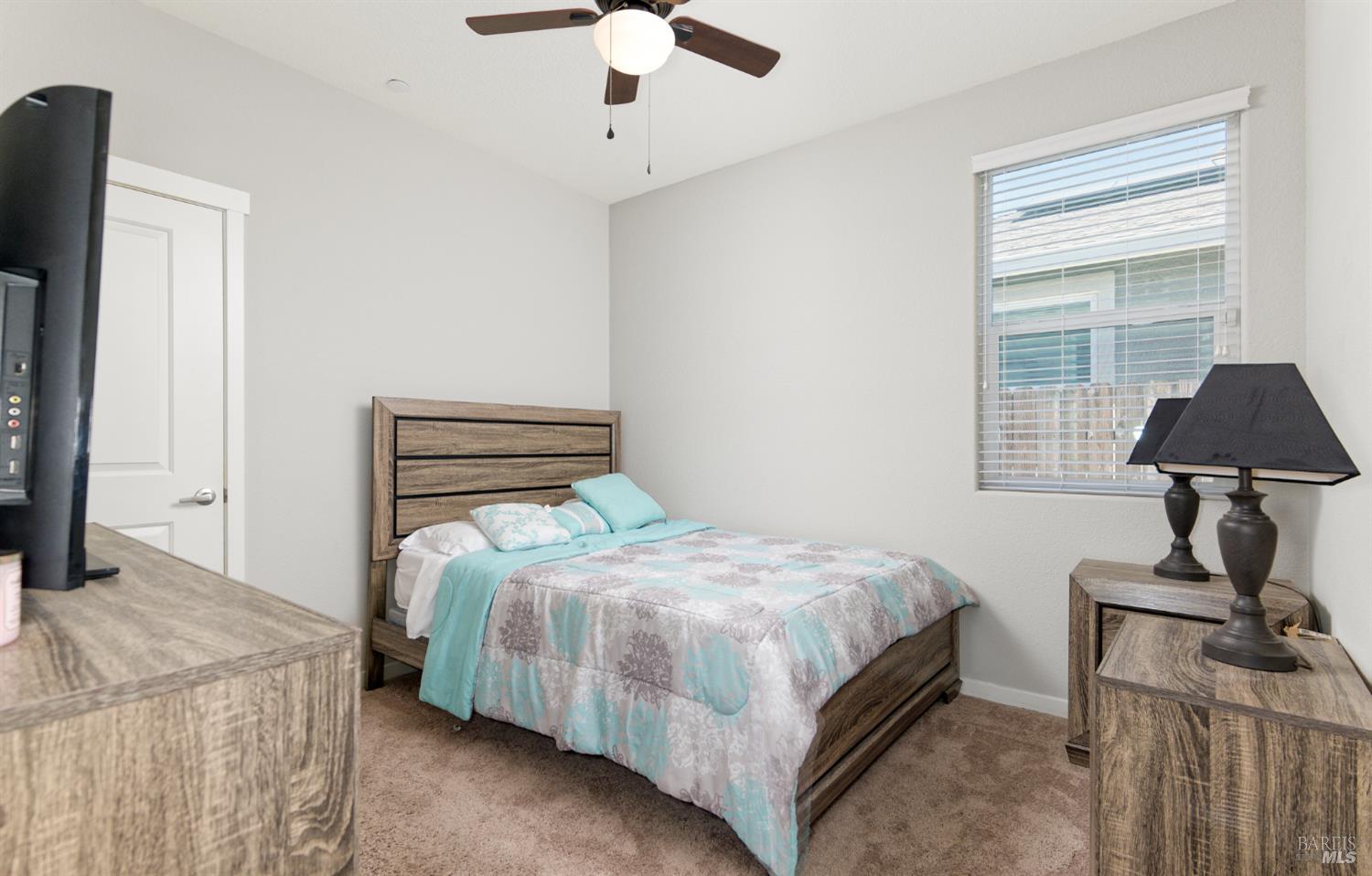 2211 Stars Drive Rio Vista, CA 94571 - Photo 14 of 24 a bedroom with a bed and a chandelier