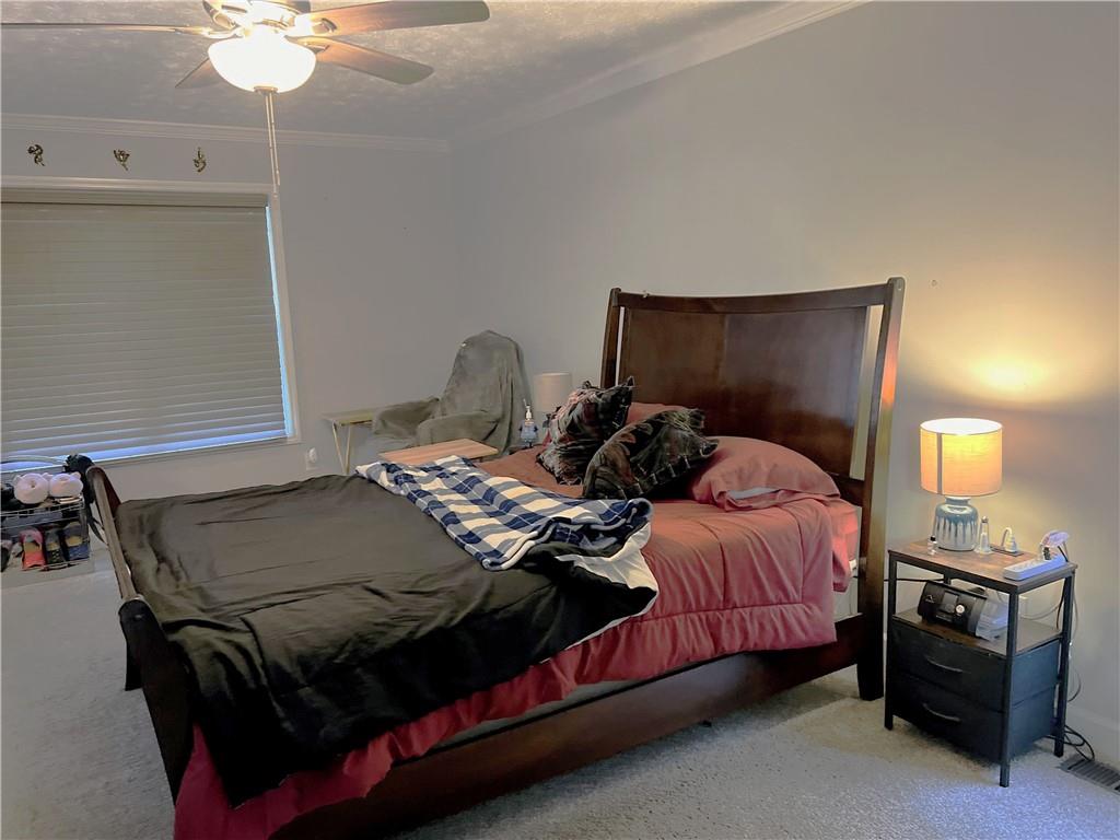 3735 Warwick Way Snellville, GA 30039 - Photo 12 of 28 a bedroom with a bed and a chandelier