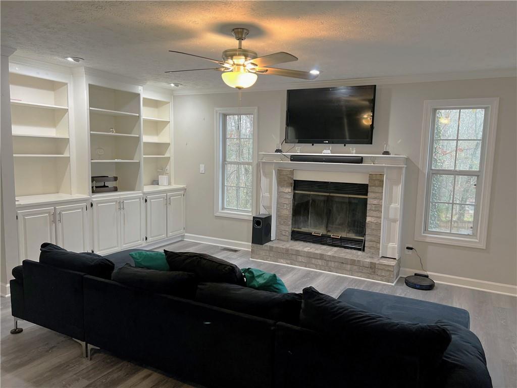 3735 Warwick Way Snellville, GA 30039 - Photo 5 of 28 a living room with furniture a fireplace and a flat screen tv
