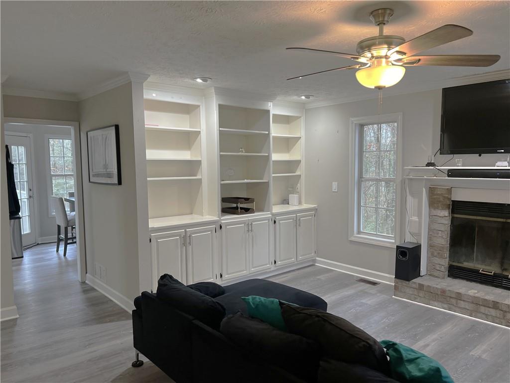 3735 Warwick Way Snellville, GA 30039 - Photo 6 of 28 a living room with furniture a flat screen tv and kitchen view