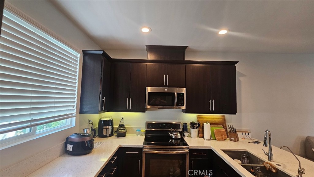 8073 Ackerman Street Buena Park, CA 90621 - Photo 11 of 43 a kitchen with a sink and a stove top oven