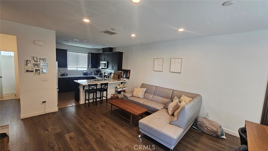 8073 Ackerman Street Buena Park, CA 90621 - Photo 15 of 43 a living room with stainless steel appliances furniture and a wooden floor