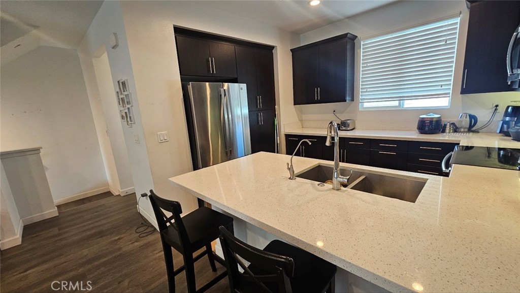 8073 Ackerman Street Buena Park, CA 90621 - Photo 16 of 43 a kitchen with stainless steel appliances a sink and a refrigerator