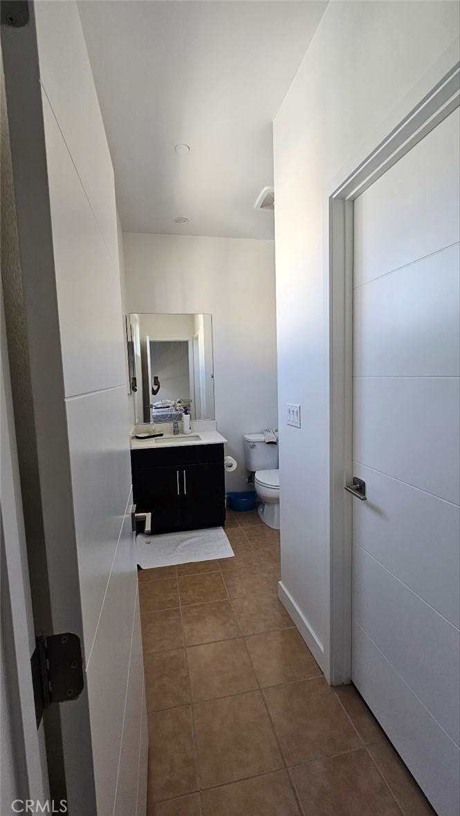 8073 Ackerman Street Buena Park, CA 90621 - Photo 24 of 43 a bathroom with a sink a mirror and a toilet