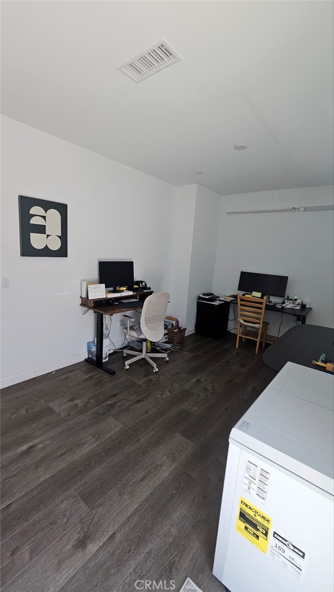 8073 Ackerman Street Buena Park, CA 90621 - Photo 29 of 43 a view of a workspace with furniture and wooden floor
