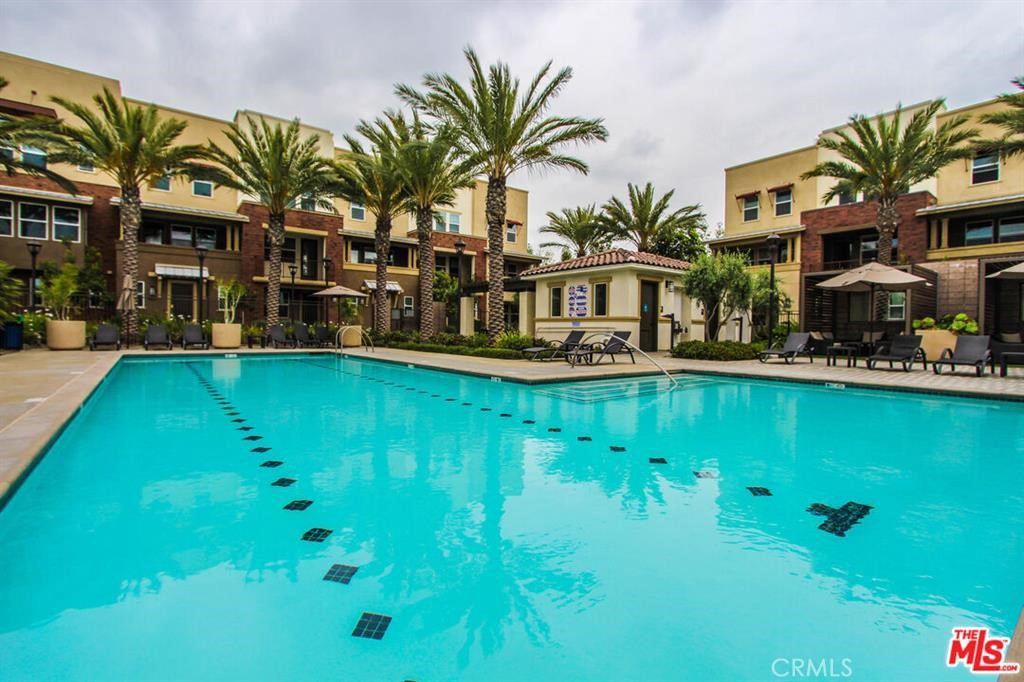 8073 Ackerman Street Buena Park, CA 90621 - Photo 34 of 43 a front view of a house with garden and swimming pool