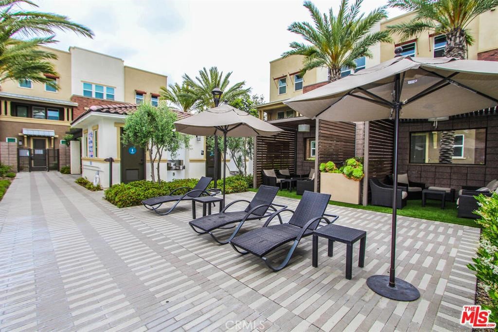 8073 Ackerman Street Buena Park, CA 90621 - Photo 39 of 43 a view of a patio with table and chairs under an umbrella