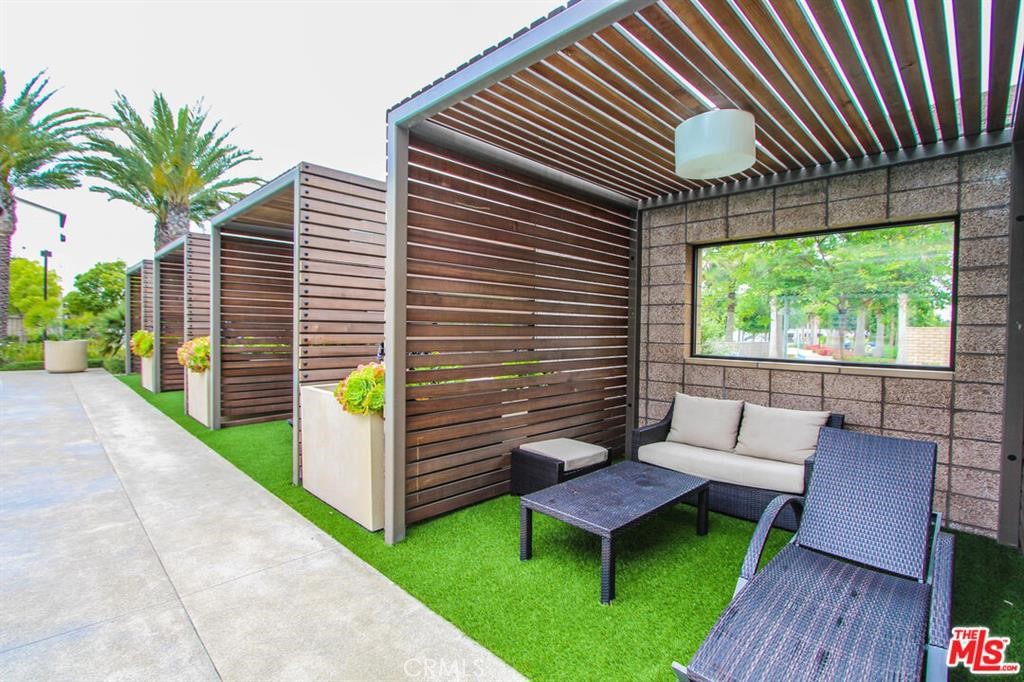 8073 Ackerman Street Buena Park, CA 90621 - Photo 40 of 43 a view of a chair and tables in the patio in front of house