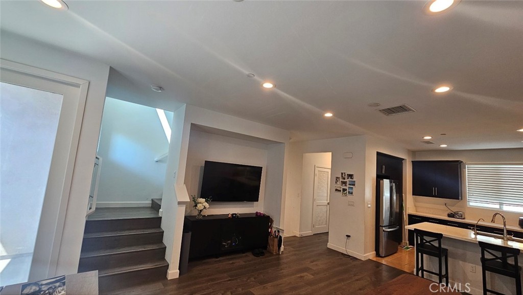 8073 Ackerman Street Buena Park, CA 90621 - Photo 4 of 43 a view of a livingroom with kitchen and fireplace