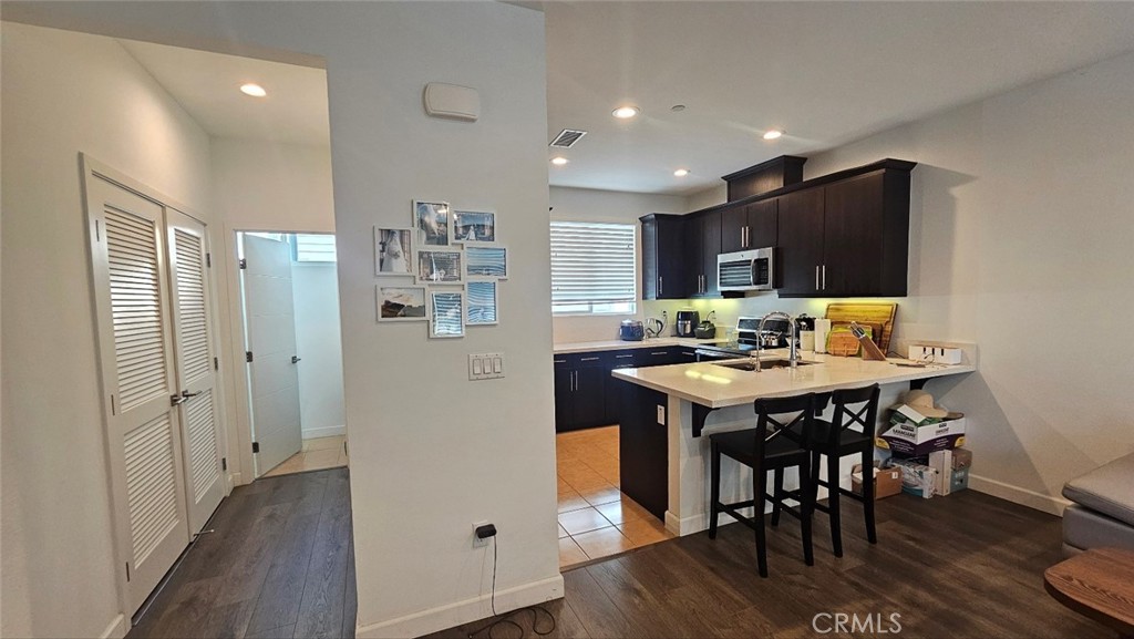 8073 Ackerman Street Buena Park, CA 90621 - Photo 9 of 43 a kitchen with stainless steel appliances granite countertop a refrigerator and a stove top oven