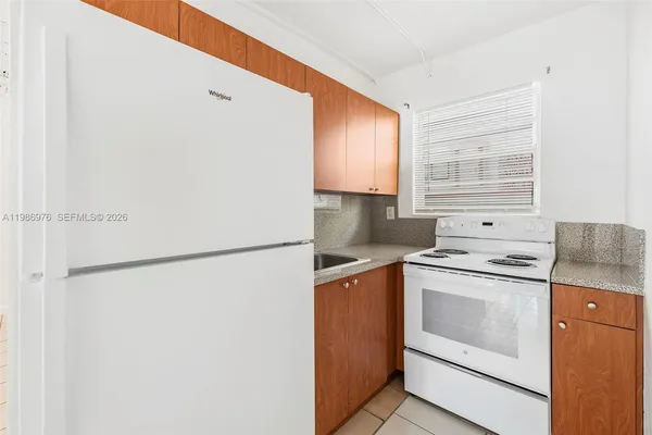 a kitchen with a stove a refrigerator and a sink