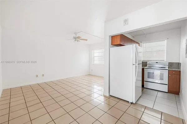 a kitchen with white cabinets and white appliances
