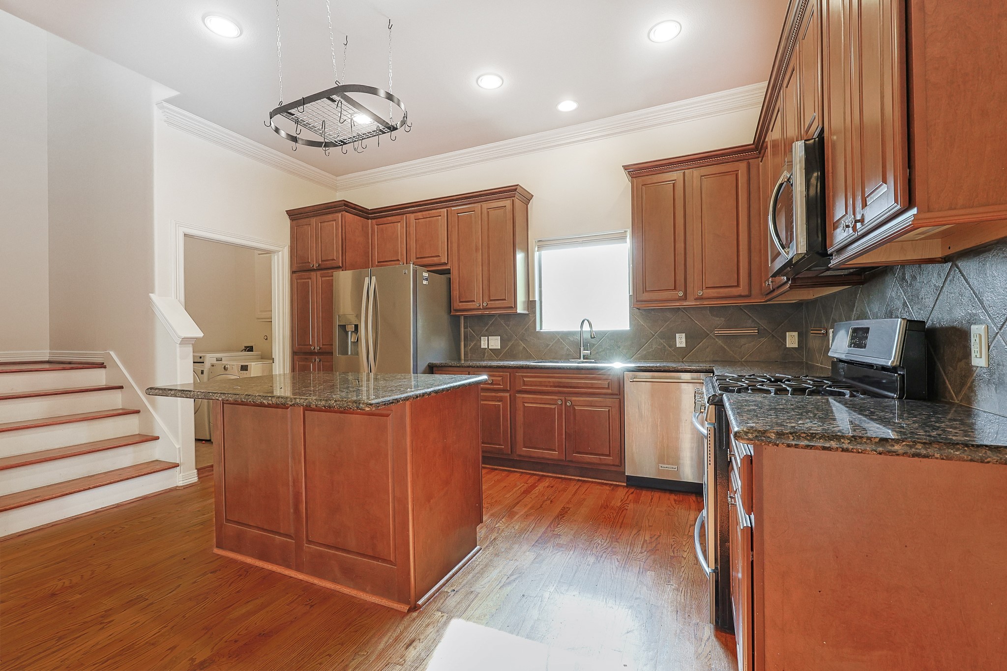 2540 Prospect Street, Unit C Houston, TX 77004 - Photo 10 of 31 a kitchen with stainless steel appliances granite countertop a stove a sink dishwasher and microwave oven with cabinets