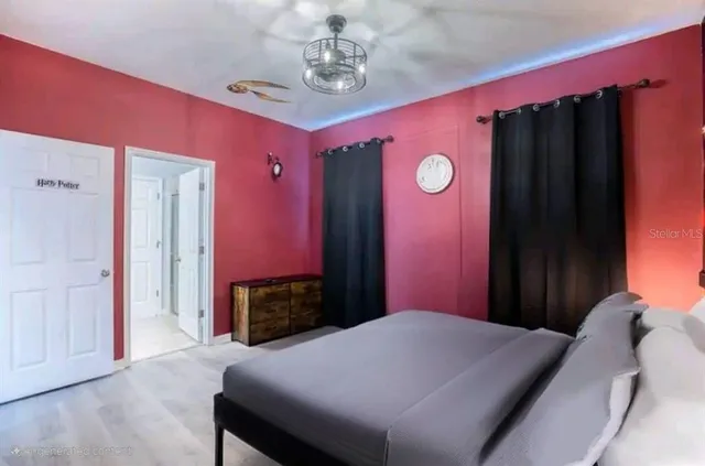 a bedroom with a bed dresser and a window