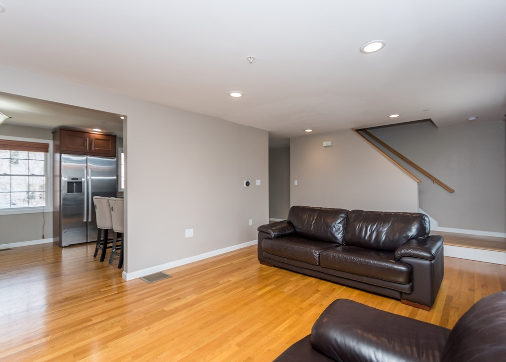 985 Trapelo Road, Unit 23 Waltham, MA 02452 - Photo 13 of 27 a living room with furniture and a couch