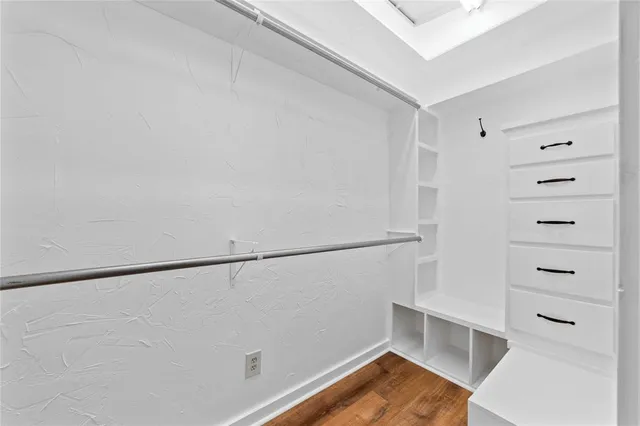 a view of walk in closet with empty racks