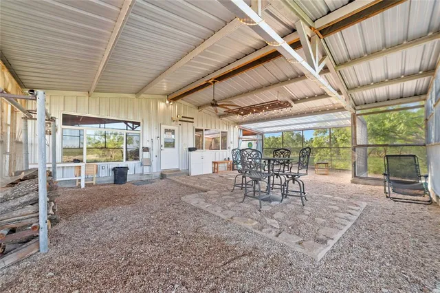 an aerial view of a house with a garden and lake view
