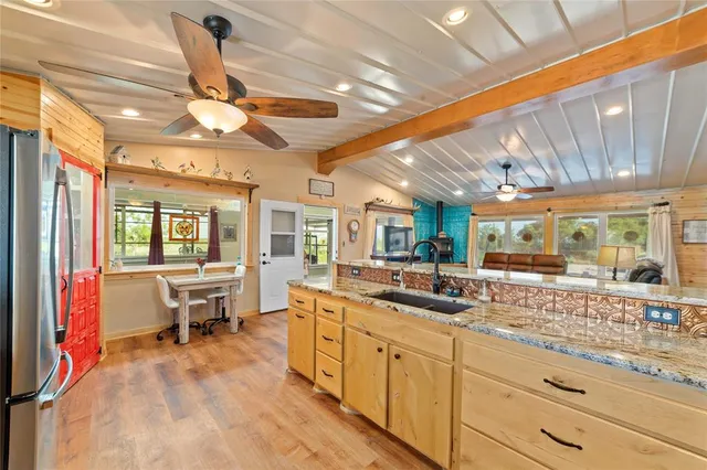 a large white kitchen with a large window