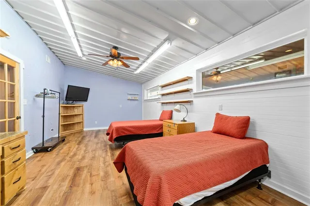 a bedroom with two beds and a flat screen tv