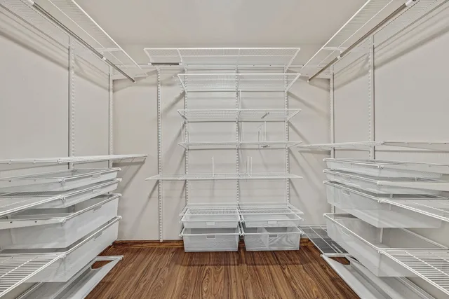 a view of walk in closet and empty room