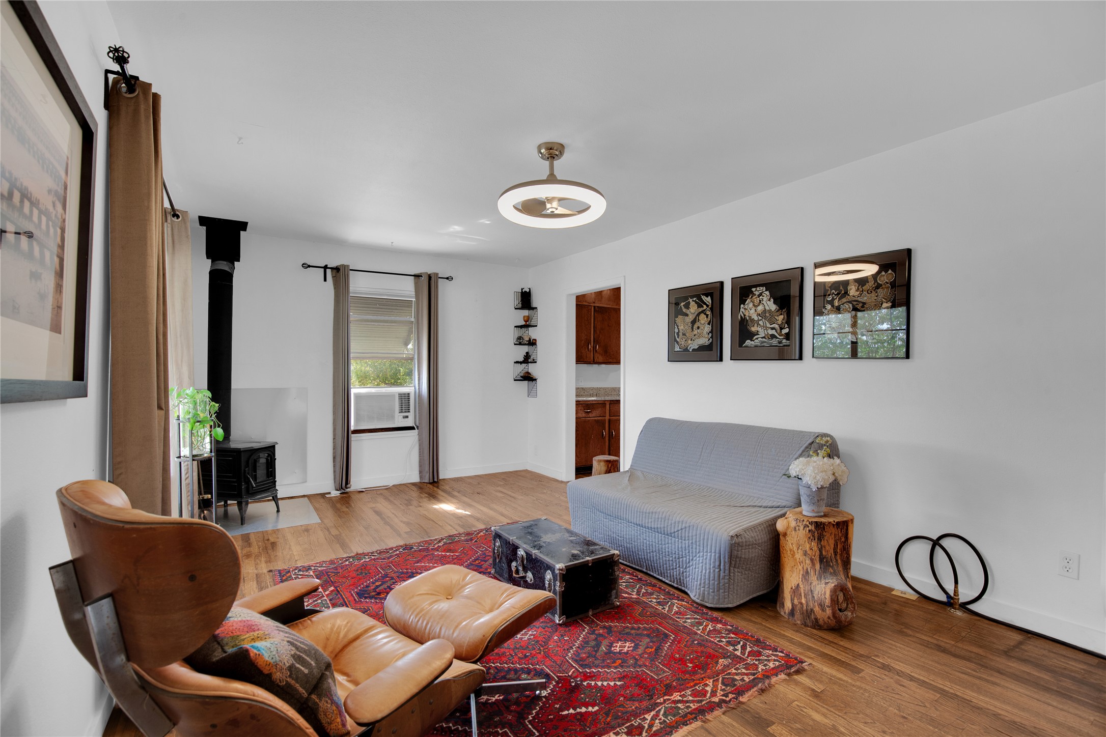 Living room featuring wood finished floors and a wood stove