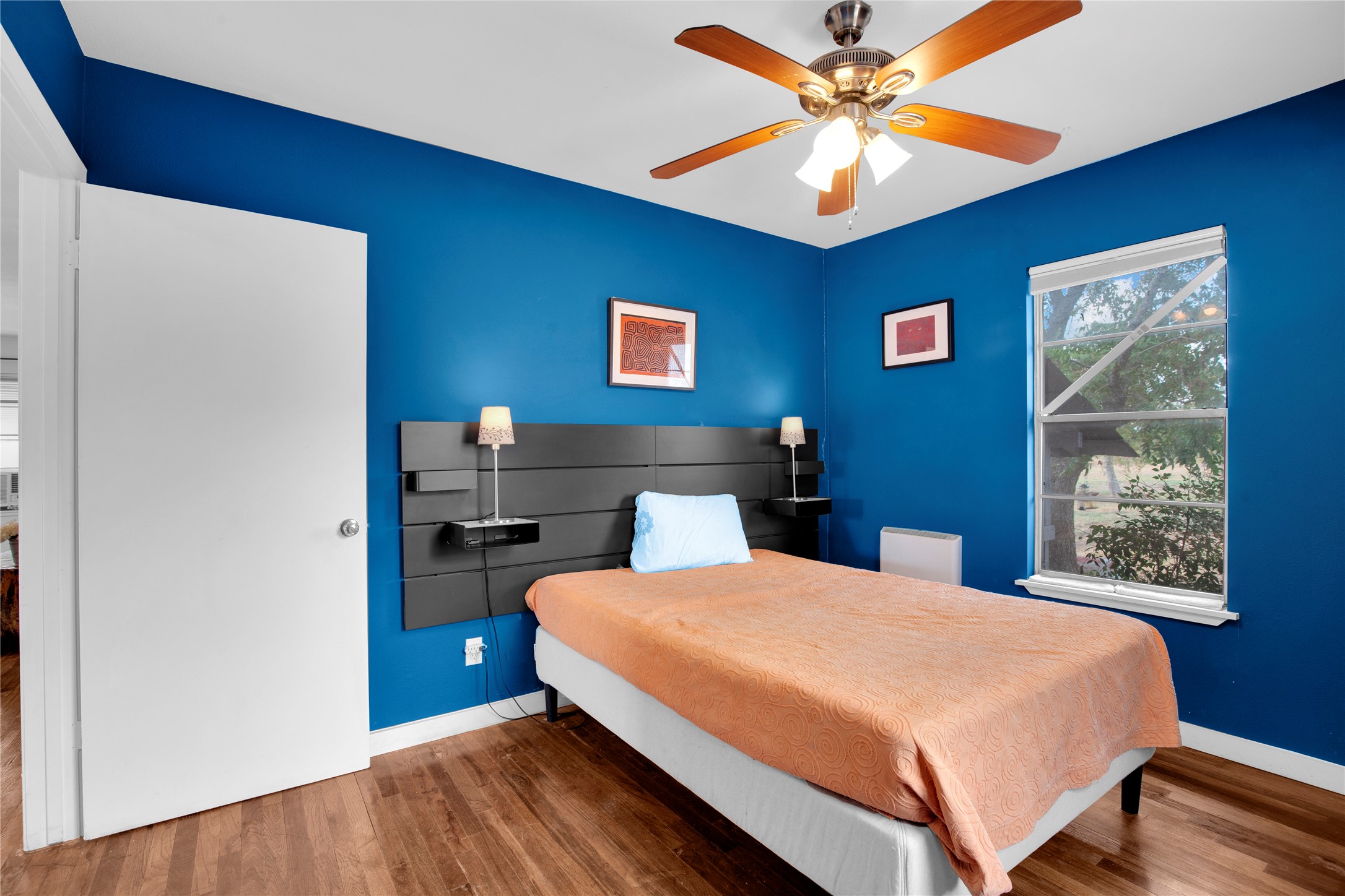 1607 East 4th Street Taylor, TX 76574 - Photo 19 of 32 Bedroom with wood finished floors and ceiling fan