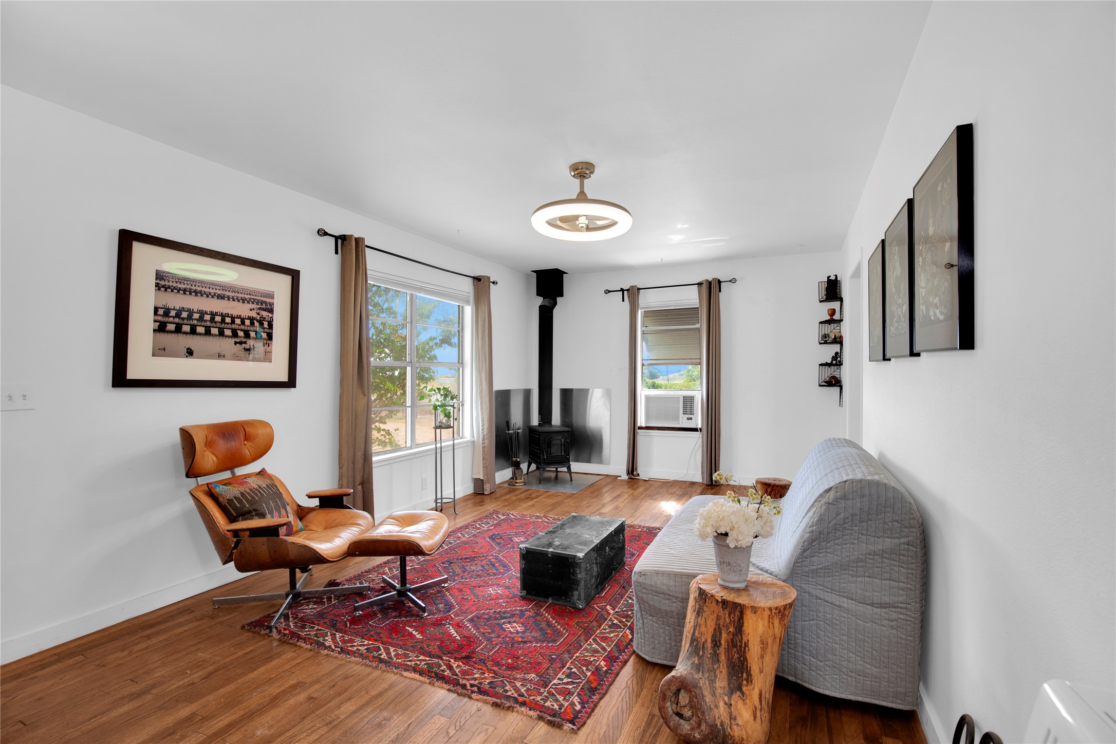 1607 East 4th Street Taylor, TX 76574 - Photo 2 of 32 Living area featuring a wood stove and wood finished floors