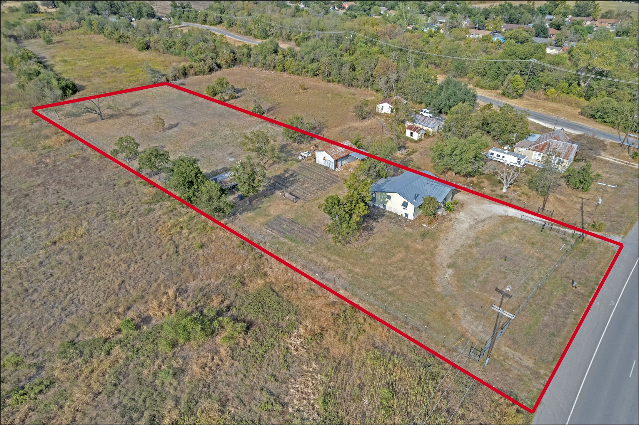 1607 East 4th Street Taylor, TX 76574 - Photo 32 of 32 Aerial view of property and surrounding area featuring property boundaries highlighted and rural landscape
