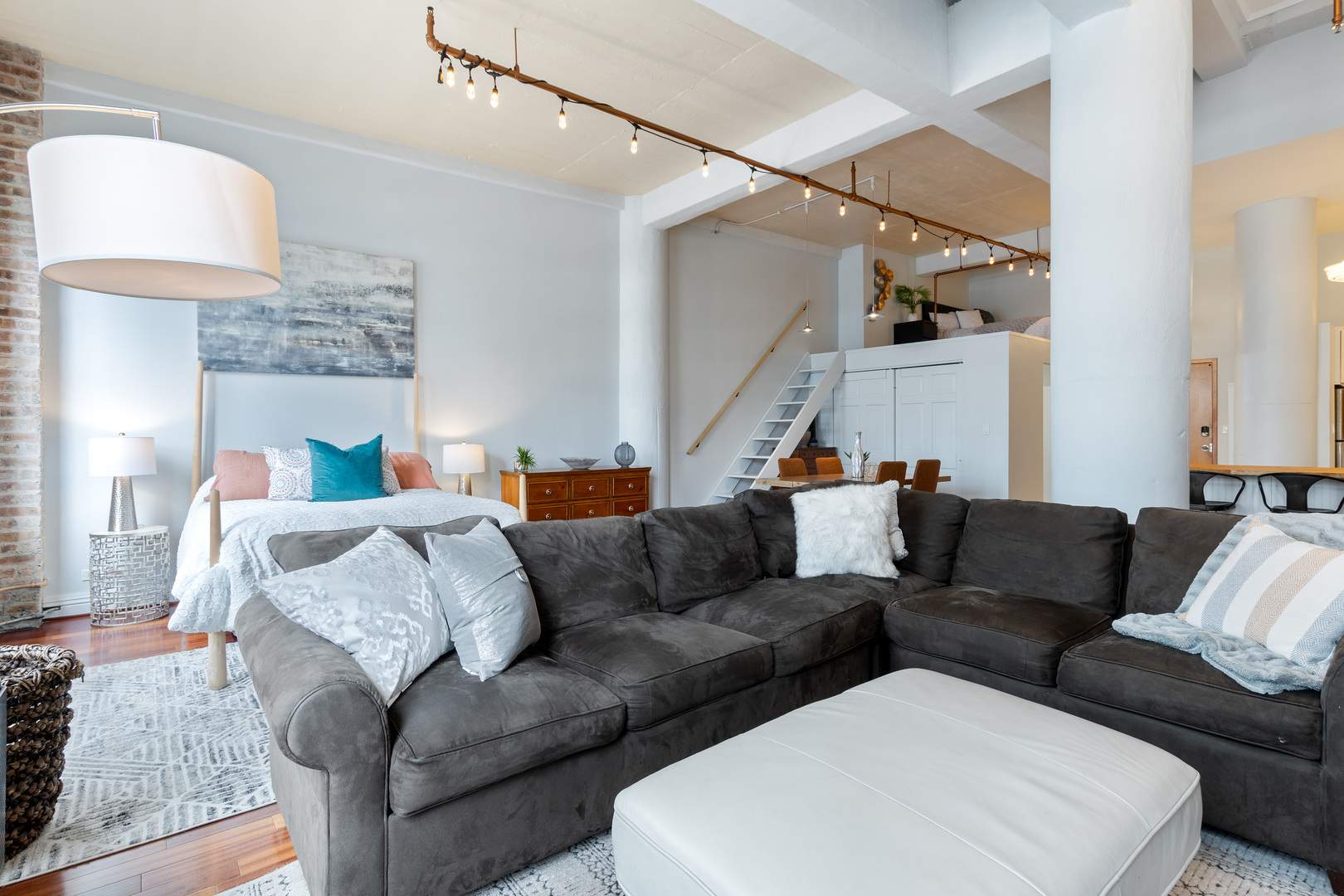 801 South Wells Street, Unit 1006 Chicago, IL 60607 - Photo 11 of 25 a living room with furniture and a lamp