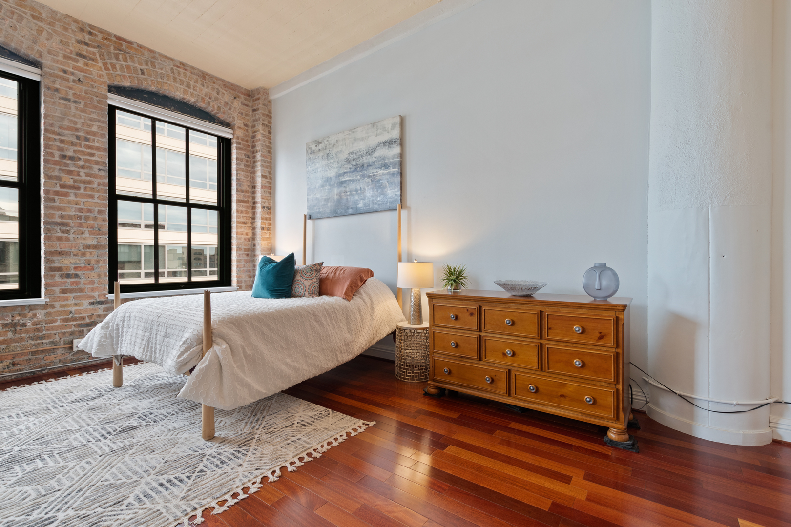 801 South Wells Street, Unit 1006 Chicago, IL 60607 - Photo 13 of 25 a bedroom with a bed and a dresser next to a window