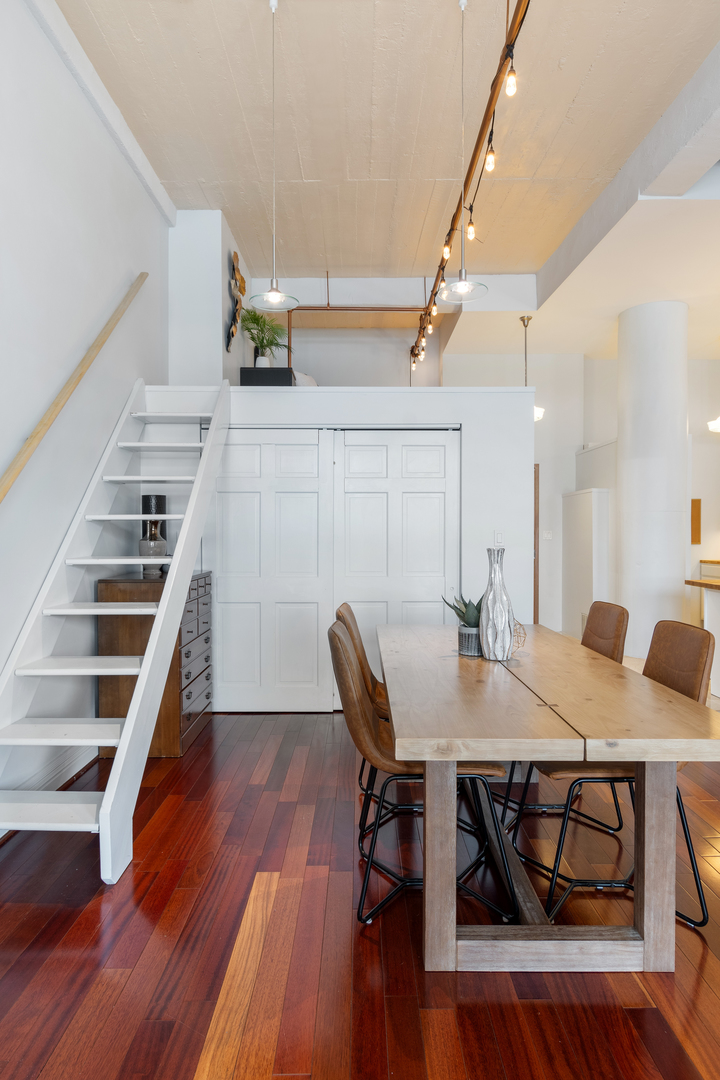 801 South Wells Street, Unit 1006 Chicago, IL 60607 - Photo 15 of 25 a view of a dining room with furniture and wooden floor