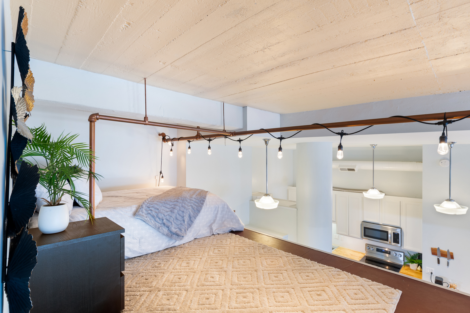 801 South Wells Street, Unit 1006 Chicago, IL 60607 - Photo 16 of 25 a bedroom with a bed and a potted plant