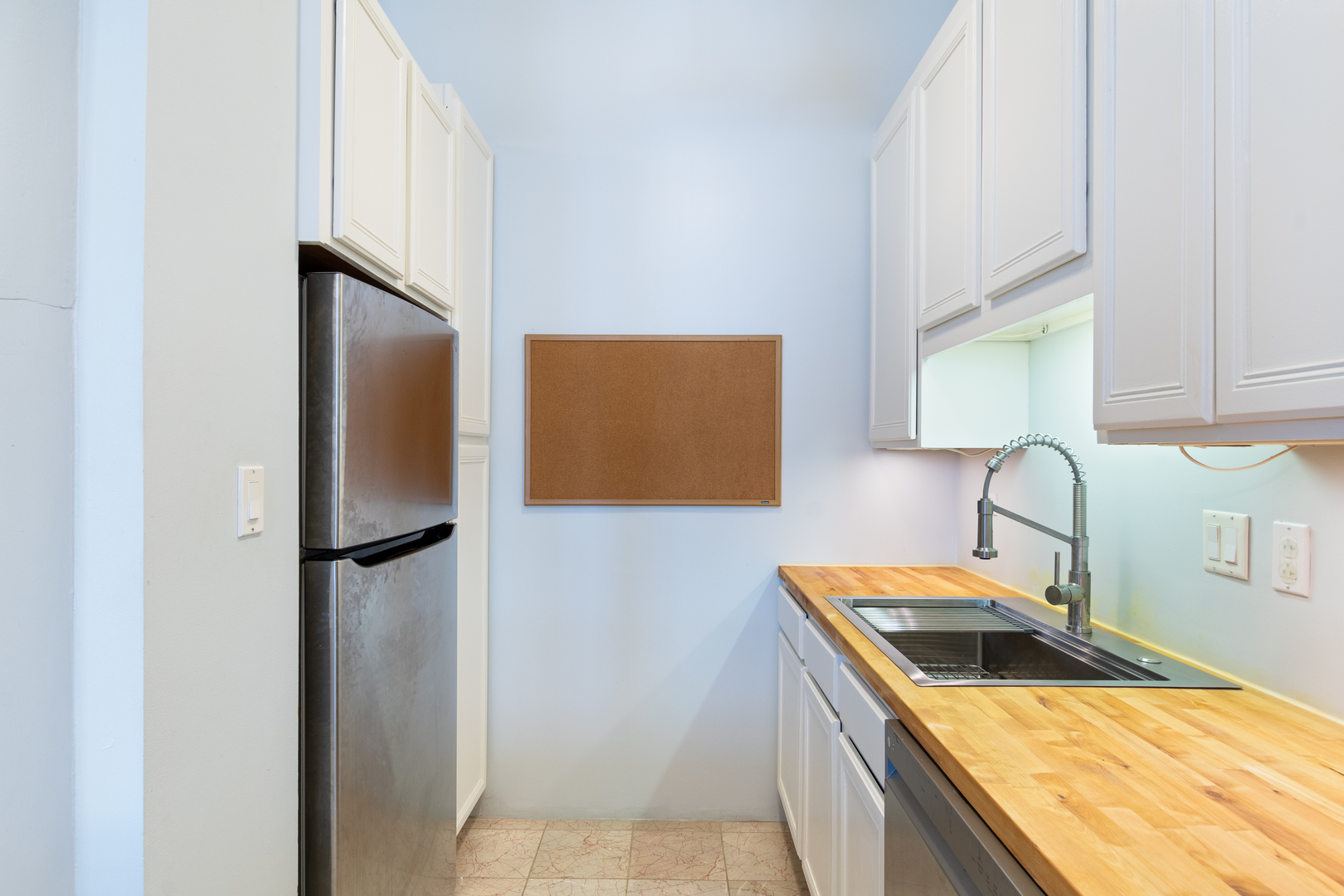 801 South Wells Street, Unit 1006 Chicago, IL 60607 - Photo 5 of 25 a kitchen with stainless steel appliances granite countertop a refrigerator and a sink