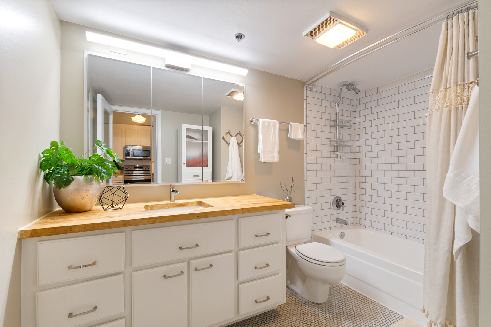 801 South Wells Street, Unit 1006 Chicago, IL 60607 - Photo 7 of 25 a bathroom with a granite countertop sink a toilet a mirror a vanity a bathtub and shower