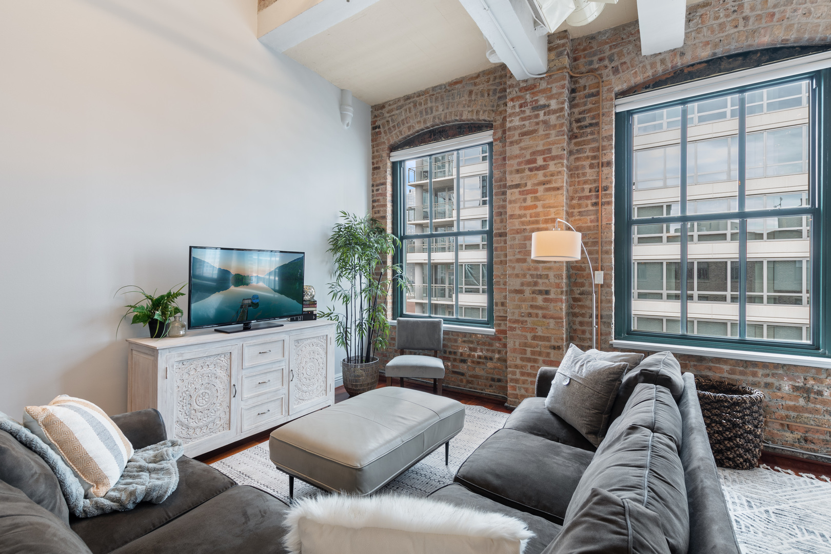 801 South Wells Street, Unit 1006 Chicago, IL 60607 - Photo 10 of 25 a living room with furniture and a flat screen tv